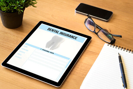 dental insurance form on tablet on desk