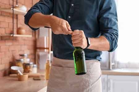 Man opens bottle with opener