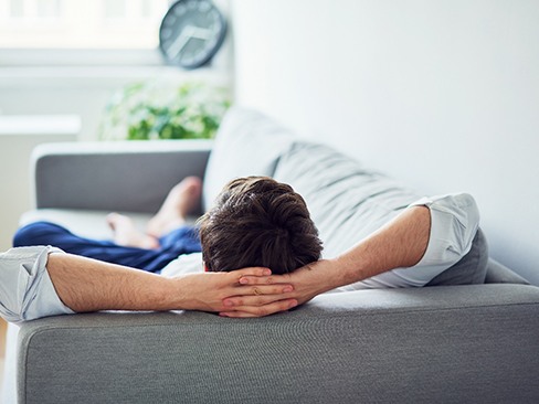 Man resting peacefully on sofa at home